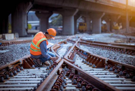 -1269800276-612x612 Portrait engineer under inspection and checking construction process railway switch and checking work on railroad station .Engineer wearing safety uniform and safety helmet in work.