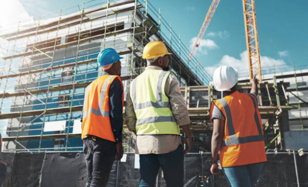Shot of a group of builders assessing progress at a construction site